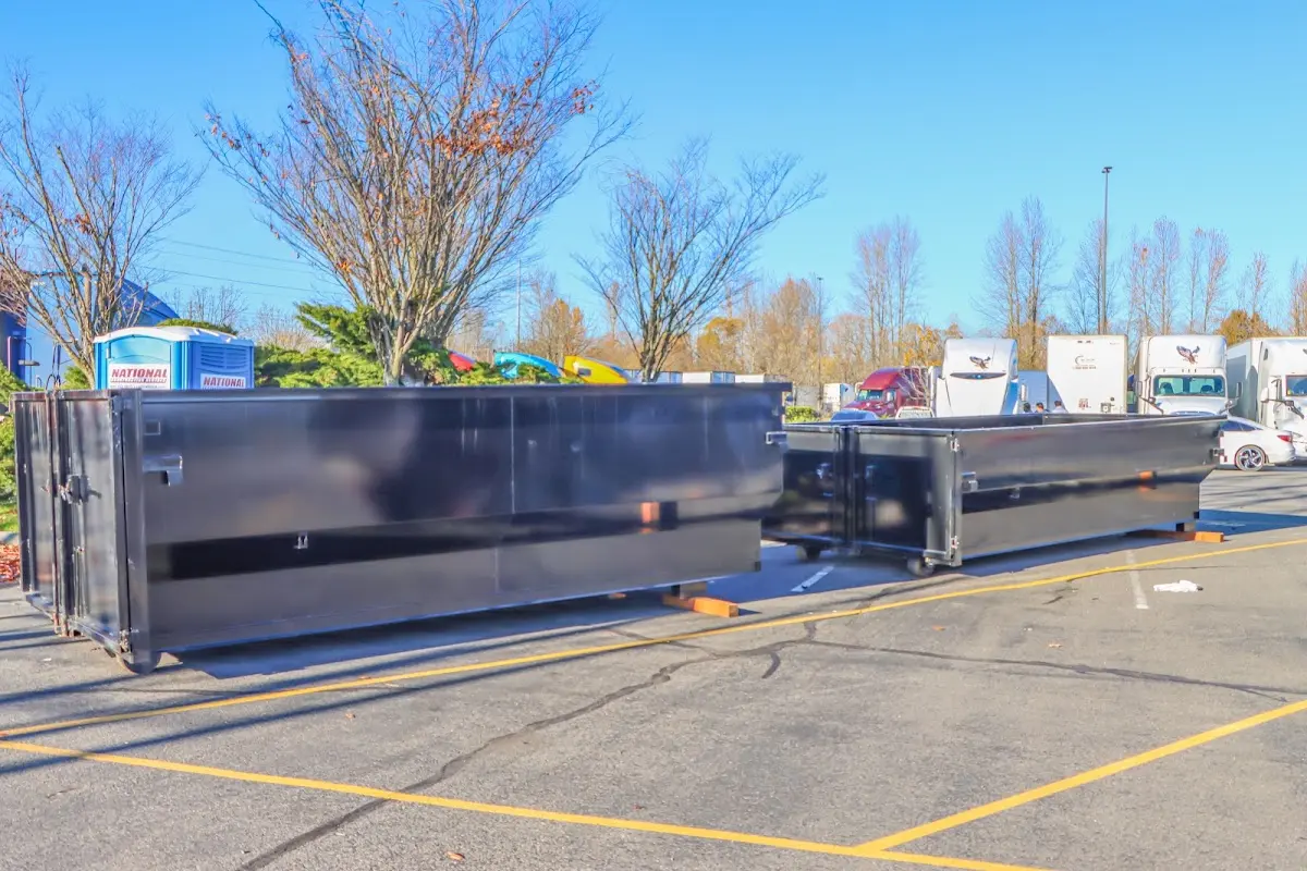 Professional dumpster rental service with roll-off container on residential driveway in Burien